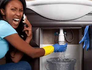 Emergency plumbing repair for a leaking sink drain under a bathroom vanity in Pasadena, CA