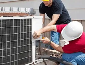 HVAC technicians repairing an outdoor AC unit on a rooftop in Pasadena, CA