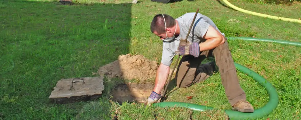 Septic pumping technician servicing a residential septic tank in Pasadena, CA